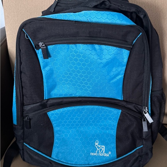 Novo Nordisk Blue and Black Backpack with Padded Design(small rip on left strap)